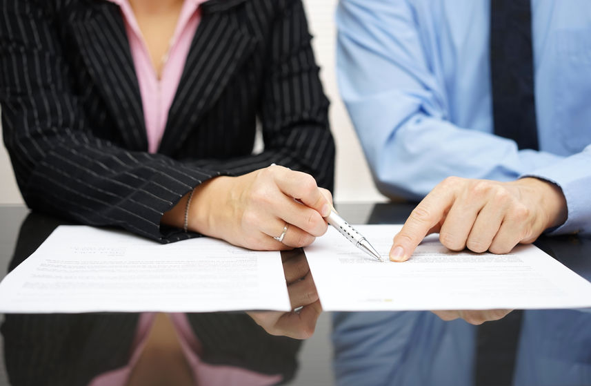 businessman and businesswoman are pointing to
article of the tr